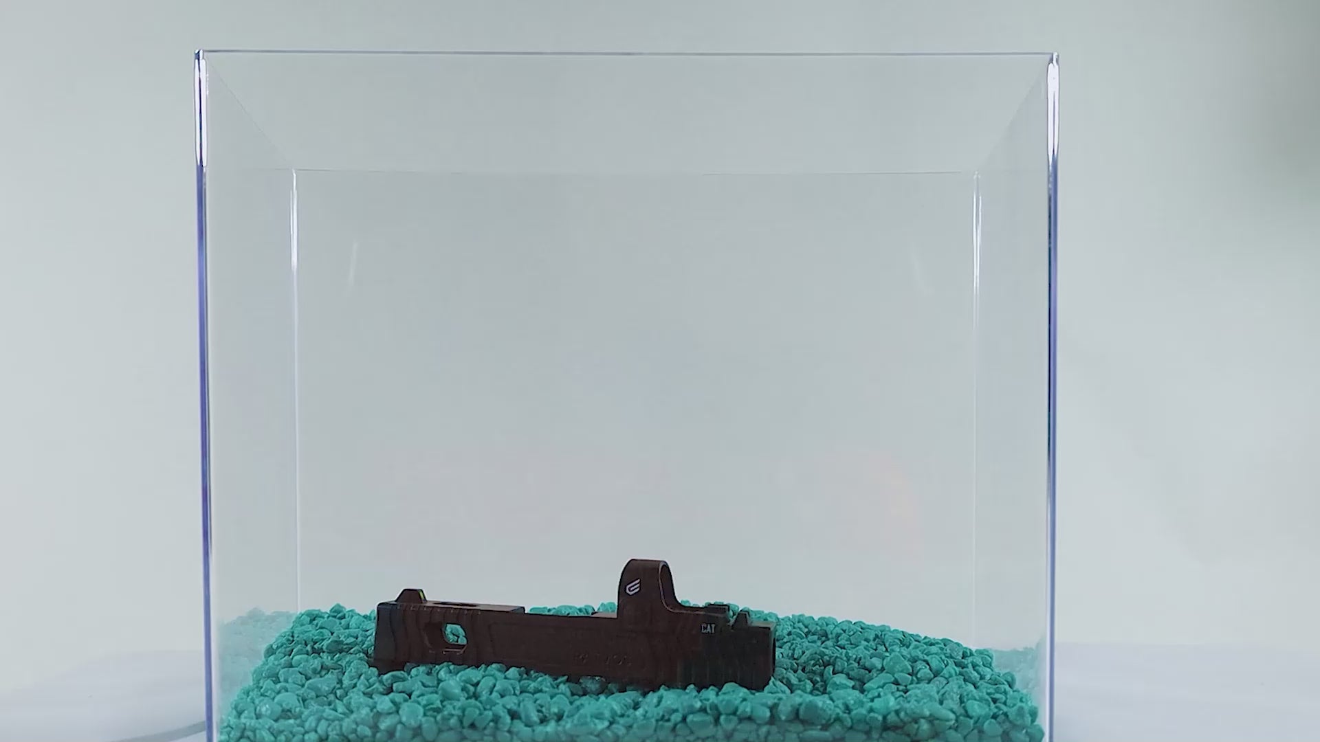 a cake in a glass case on a table